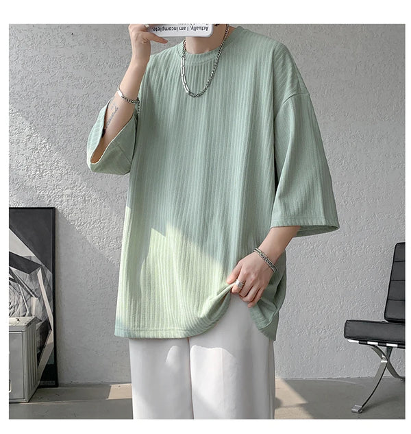 Striped summer tee displayed with denim shorts, perfect for casual summer outings.