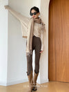 Versatile shawl in light taupe, ideal for draping or wearing as a neck warmer.