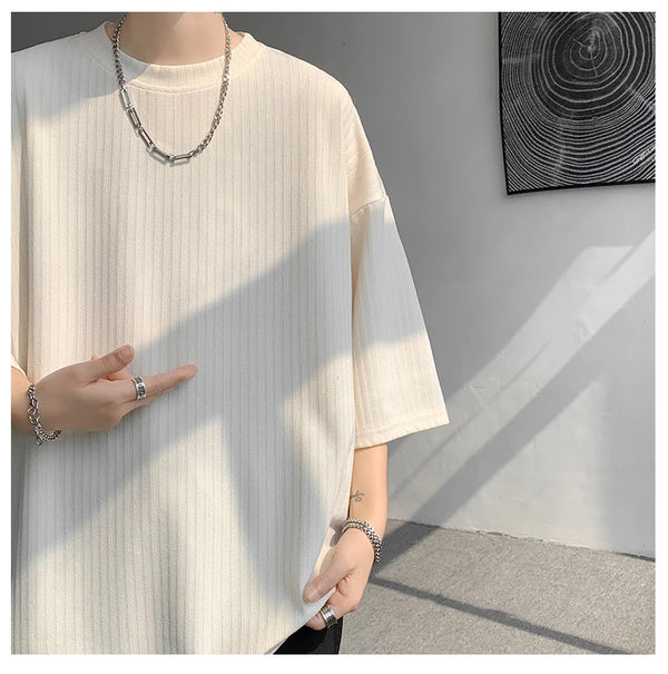 Model wearing striped tee, demonstrating its lightweight and breathable qualities.