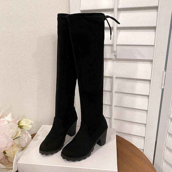 Chic over-the-knee black boots with chunky heels, lace-up detail, and comfortable cotton lining for stylish fall fashion.