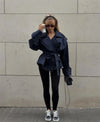 Short length trench coat with double-breasted front and waist sash