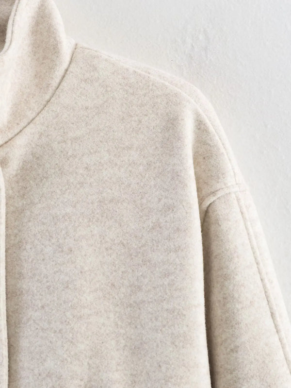 Loose-fit belted outerwear in neutral shade perfect for fall wardrobe