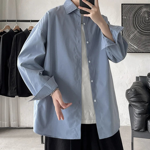 Oversized long sleeve casual shirt for men and women, featuring a Mandarin collar and single-breasted closure in solid color.