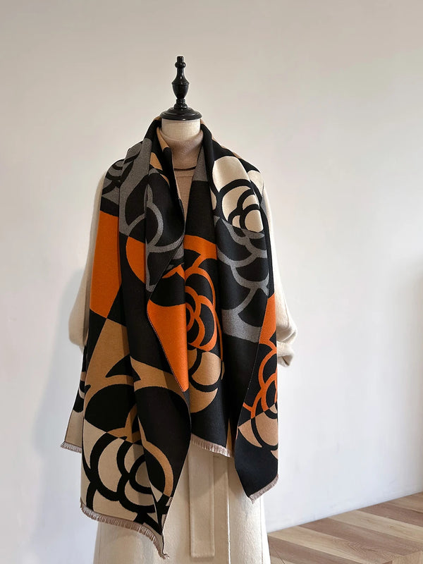 Luxury cashmere-blend women's winter scarf in elegant floral pattern.