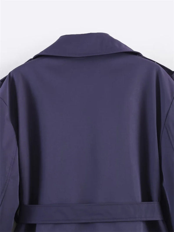 Polyester trench coat featuring double-breasted front and waist belt
