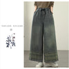 Vintage embroidered wide-leg jeans for women, featuring a comfortable elastic waist and unique ethnic-inspired designs.