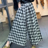 Chic plaid wide-leg pants in cotton-linen blend, featuring a high waist, pockets, and elastic waistband for comfort and style