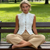 Close-up of intricate lace tatting weave texture and traditional frog button detail on crop top