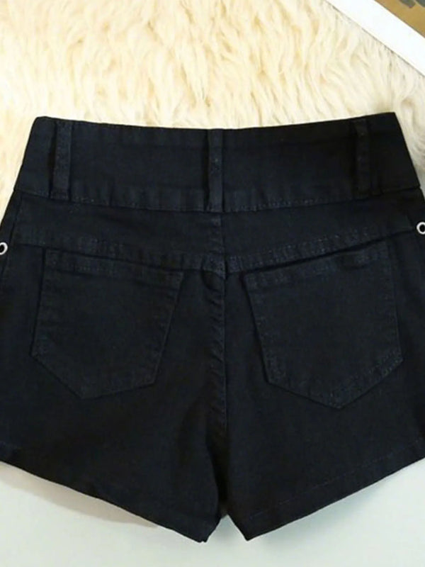 Detail shot of silver rivets and decorative hardware on black lace-up denim shorts for summer festivals