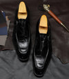 Durable construction of carved leather Oxford shoes for longevity.