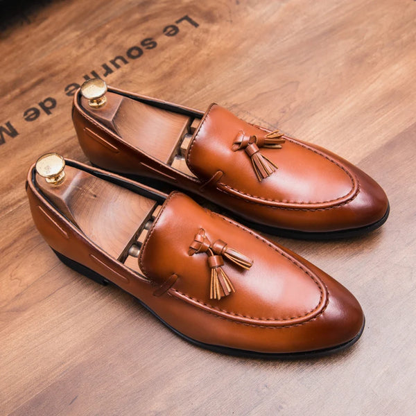 Charismatic tassel loafers in sleek black faux leather with a stylish design.
