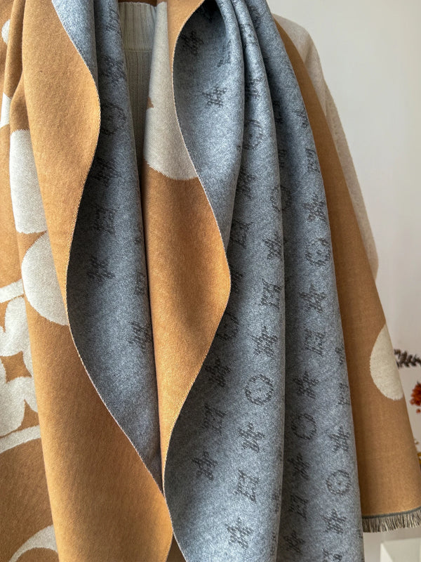 Soft gray Winter Whispers shawl draped elegantly on a chair.