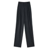 Close-up of decorative button details and high-waist construction on sophisticated wide leg trousers
