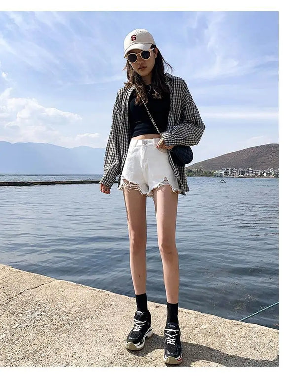 Summer casual shorts in light blue denim with edgy distressed aesthetic