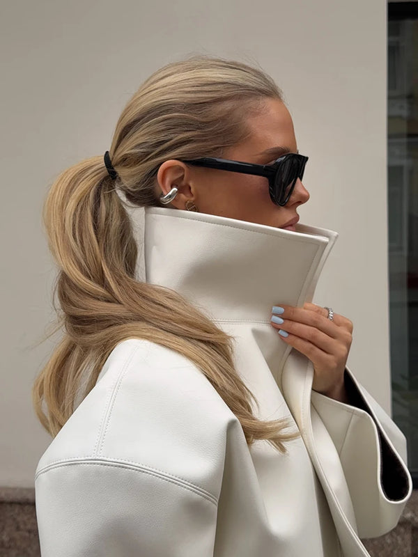 Black PU leather stand collar jacket with single-breasted closure on white background