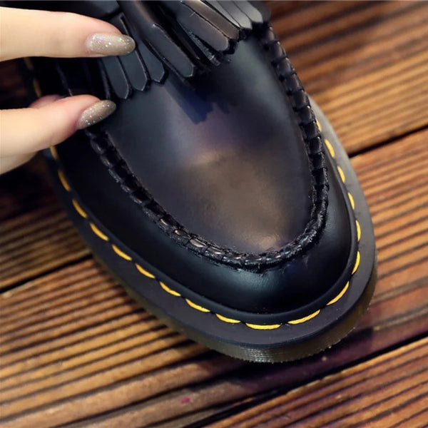 Black tassel loafers with durable TPU outsole for extended wear.