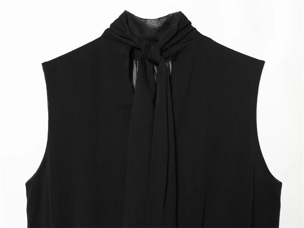 Close-up of ribbon detail on sleeveless black pleated top