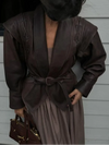 Chic belted leather bomber jacket for women, featuring lace-up detail, notched lapel, and hood for stylish autumn wear.