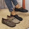 Black slip-on loafer flats for women with sleek leather finish on white background
