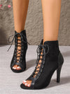 Performance footwear with super-high heels and hollow-out details that catch stage lights