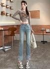 Chic high waist straight leg jeans for women in distressed wash, perfect for casual outings and office wear.
