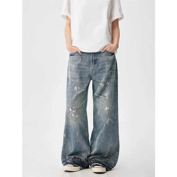 Trendy washed and ripped wide-leg women's jeans with ink-splashed finish, mid-rise, and comfortable cotton-spandex blend.