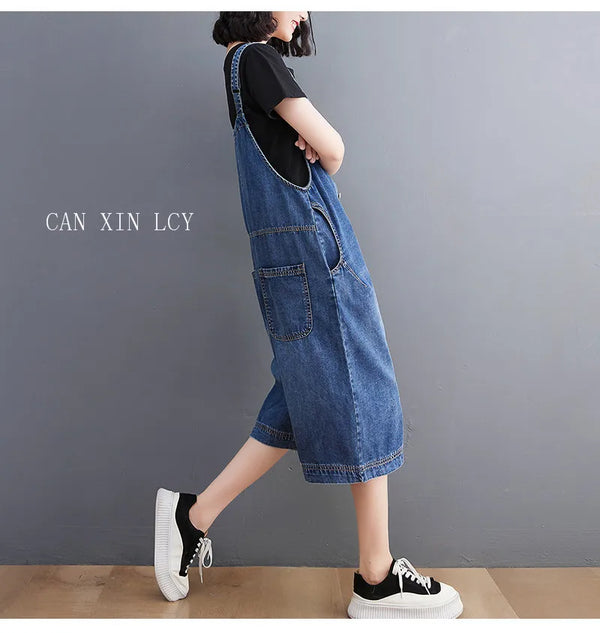 Detail shot of functional side pockets on baggy denim suspender jumpsuit for hands-free convenience