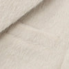 Creamy white mohair blazer texture detail highlighting plush polyester blend fabric