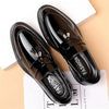 Classic black loafers featuring high-shine finish, slip-on design, and refined tassel embellishment for men