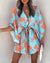 Full length view of above-knee floral dress with whimsical irregular ruffle hem