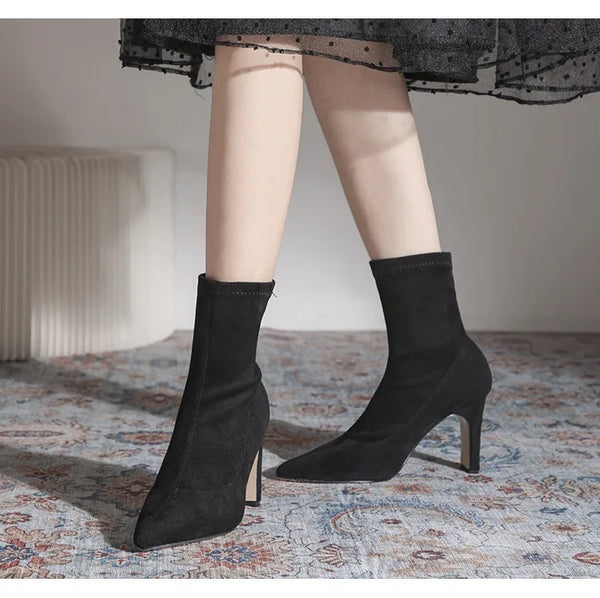 Chic black ankle boots with slim high heels, pointed toe design, perfect for autumn and winter fashion. Stylish slip-on footw