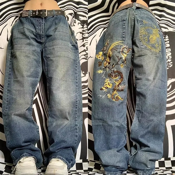 Wide-leg jeans in blue denim with bold joker pattern embroidery.