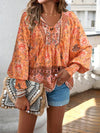 Bohemian lace-up V-neck blouse for women with vibrant print, lantern sleeves, and loose fit, perfect for spring and summer.