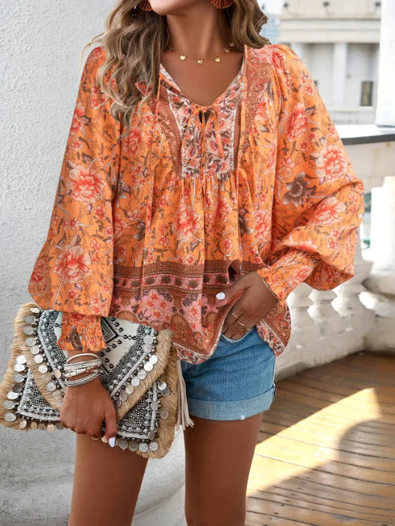 Bohemian lace-up V-neck blouse for women with vibrant print, lantern sleeves, and loose fit, perfect for spring and summer.