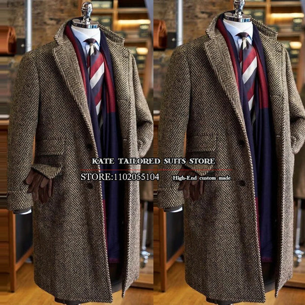 Close-up of the brown herringbone fabric of the men's trench coat, showcasing its elegant texture.