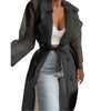 Woman styling belted trench coat with midi skirt for versatile spring look