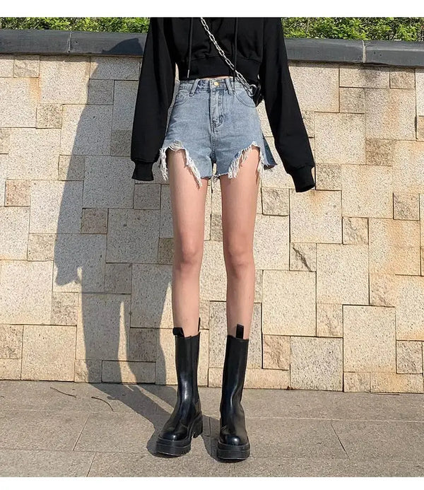 Summer denim shorts featuring high rise waist and edgy ripped details throughout