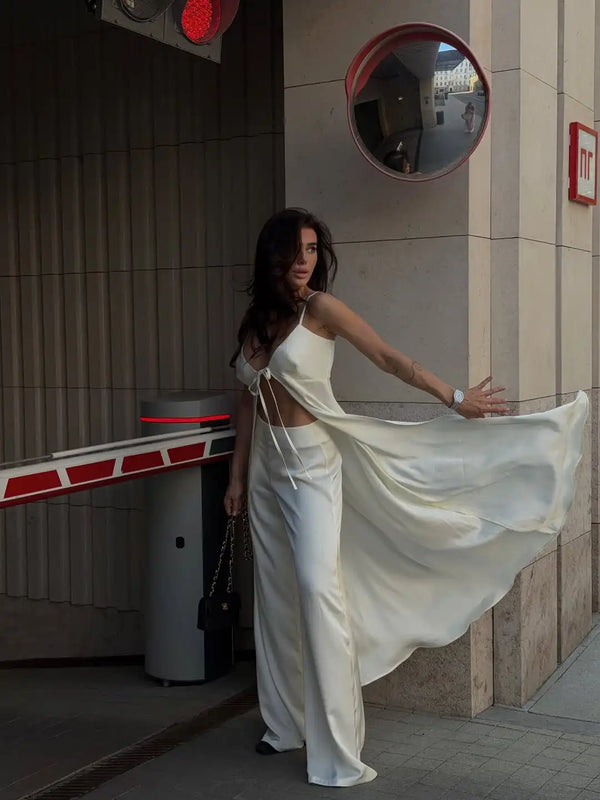 Back view of white satin two-piece set displaying tailored fit and flowing lines