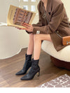 Chic black ankle boots with slim high heels, pointed toe design, perfect for autumn and winter fashion.