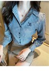 Chic striped blouse for office elegance, featuring a turn-down collar and single-breasted closure, perfect for professional w
