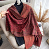 Tassel detail on lightweight paisley pashmina scarf displayed elegantly.