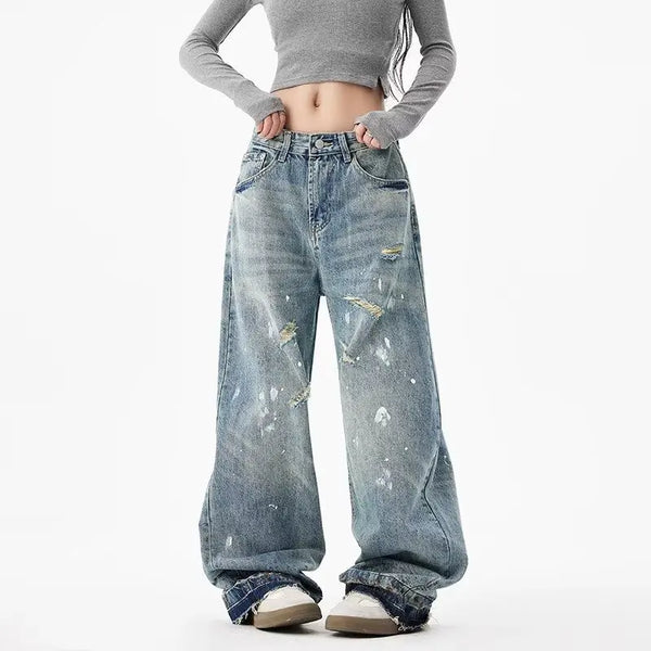 Trendy washed and ripped wide-leg women's jeans with ink-splashed finish, mid-rise, and comfortable cotton-spandex blend.
