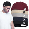 Black docker cap with adjustable fit and embroidered detail on white background