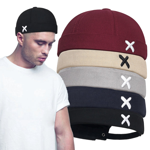 Black docker cap with adjustable fit and embroidered detail on white background