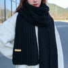 Unisex winter scarf in a classic solid color, perfect for layering.