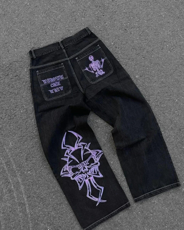 Artistic blue jeans with bold embroidery for a standout style.