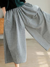 Chic plaid wide-leg pants in cotton-linen blend, featuring elastic waistband and pockets for stylish comfort. Perfect for any
