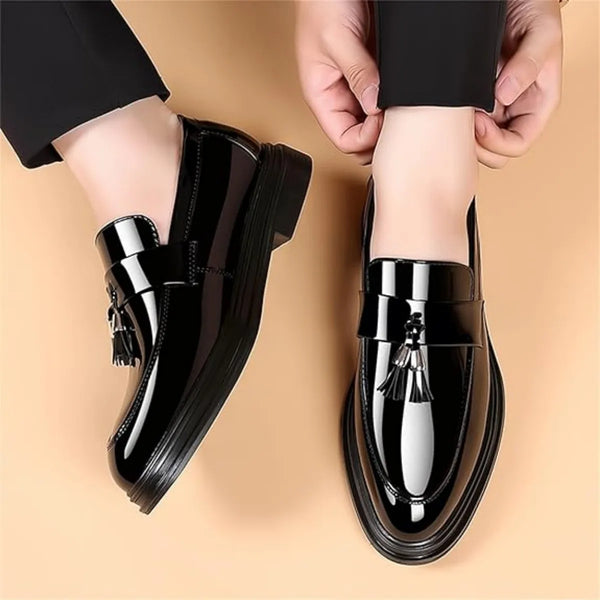 Professional black tassel loafers with lustrous finish and comfortable round toe for boardroom to evening wear