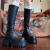 Chic black platform knee-high fashion boots with wedge heel, waterproof design, and bling accents for stylish women.