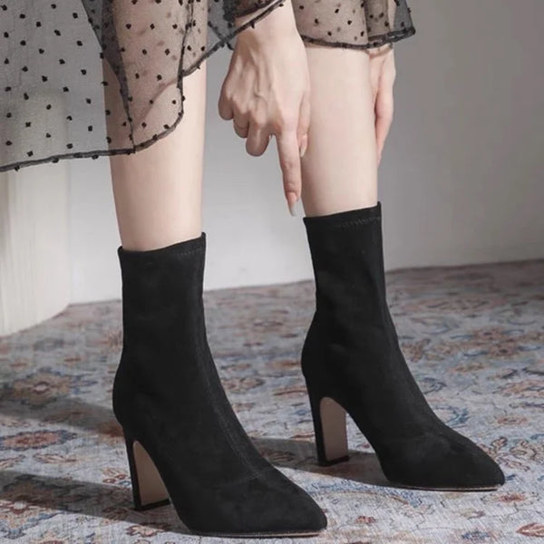 Chic black ankle boots with slim high heels, pointed toe design, perfect for autumn and winter fashion. Stylish slip-on footw